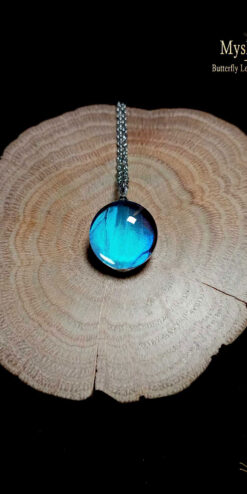 Blue Morpho butterfly necklace (18mm) with authentic Morpho deidamia wing under glass lens, handcrafted nature jewelry symbolizing transformation, peace, and good luck