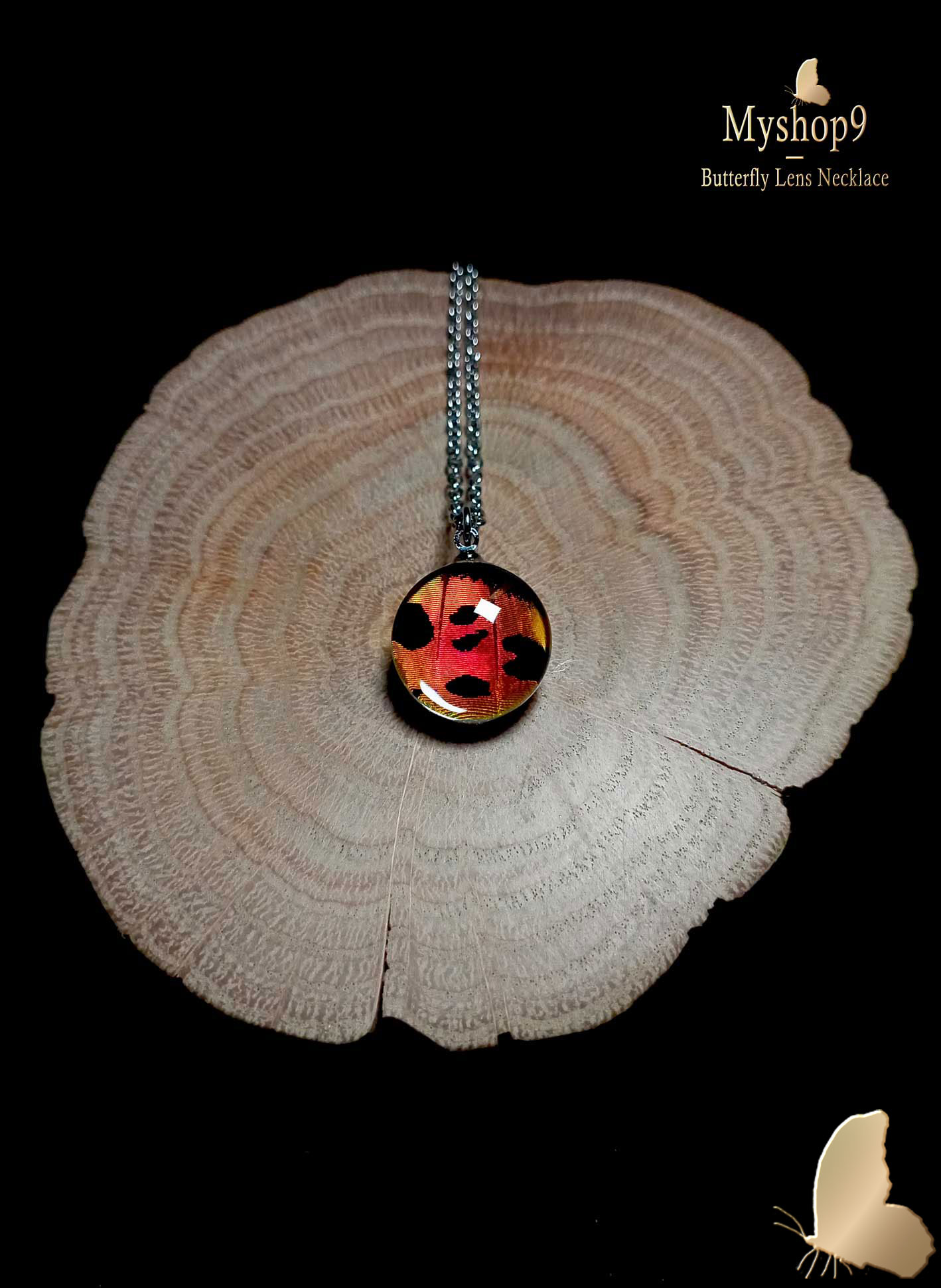 Handmade sunset butterfly wing necklace (16mm) with real Urania ripheus wing in red, orange, and pink preserved under glass lens, iridescent nature-inspired jewelry